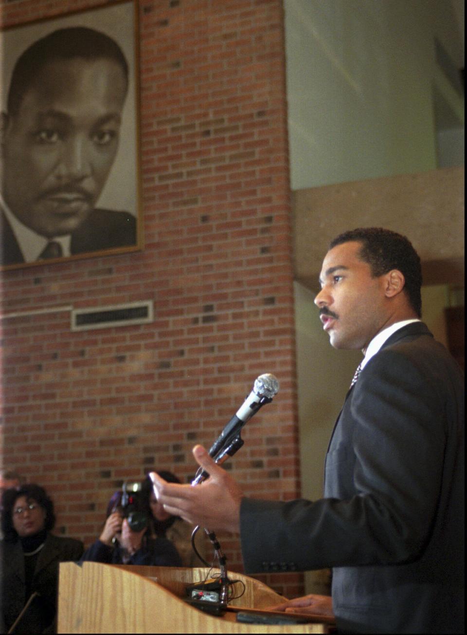 FILE - Dexter King, son of slain civil rights leader Martin Luther King Jr., pictured in background, speaks to the media during a news conference Thursday, Feb. 13, 1997, in Atlanta in which the King family asked that James Earl Ray be brought to trial for the murder of Martin Luther King, Jr. The King Center in Atlanta said the 62-year-old son of the civil rights leader died Monday, Jan. 22, 2024 at his California home after battling prostate cancer. (AP Photo/Alan Mothner, File)