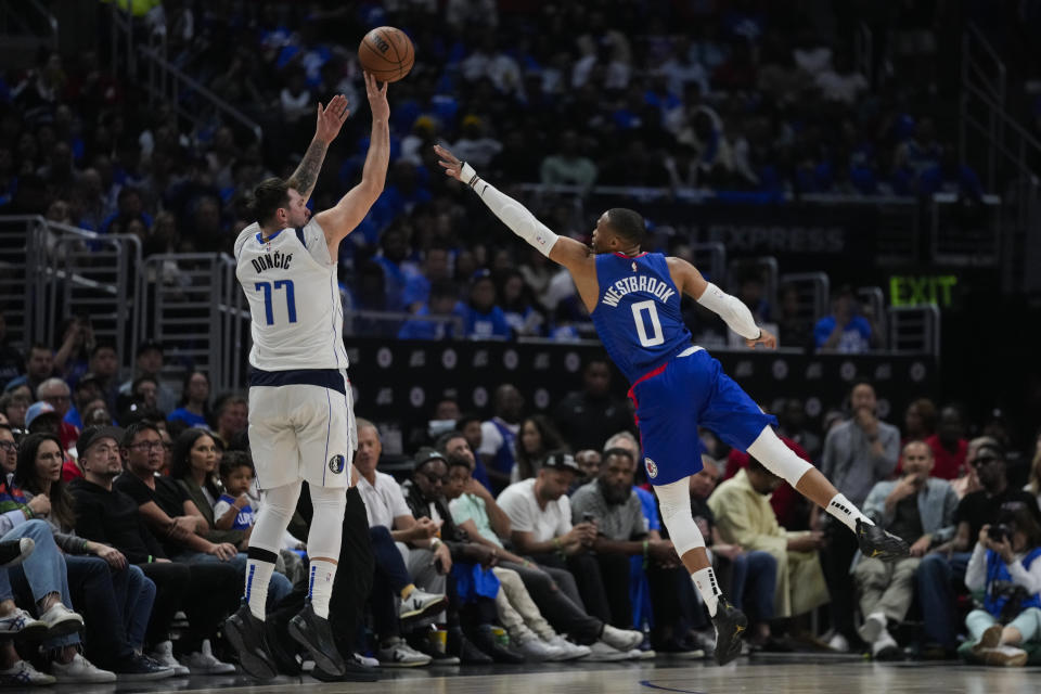 Dallas Mavericks guard Luka Doncic (77) shoots against LA Clippers guard Russell Westbrook (0) during the second half of Game 1 of an NBA basketball first-round playoff series in Los Angeles, Sunday, April 21, 2024. (AP Photo/Ashley Landis)