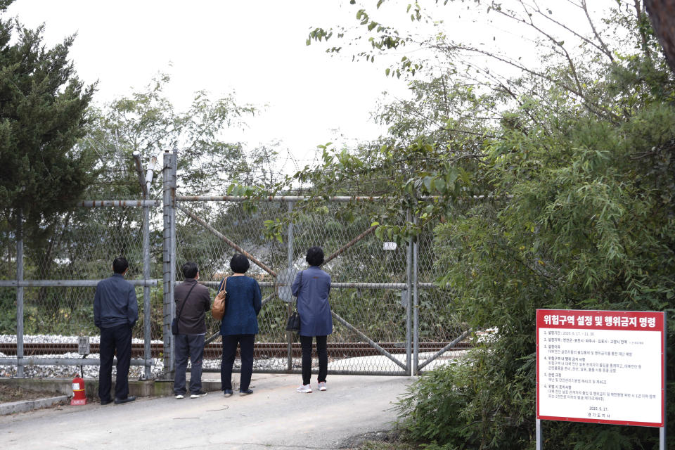 South Korean visitors watch the northern side through the barbed wire fence as they visit to celebrate the Chuseok, the Korean version of Thanksgiving Day, at Imjingak Pavilion in Paju, near the border with North Korea, South Korea, Thursday, Oct. 1, 2020. The government has discouraged people from visiting their hometowns for the Chuseok holiday amid concerns about the spread of the coronavirus. (AP Photo/Ahn Young-joon)