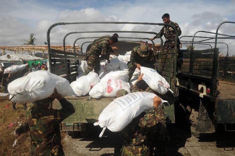 Soldiers load relief goods to a truck in Tacloban, Leyte province, central Philippines on November 13, 2013