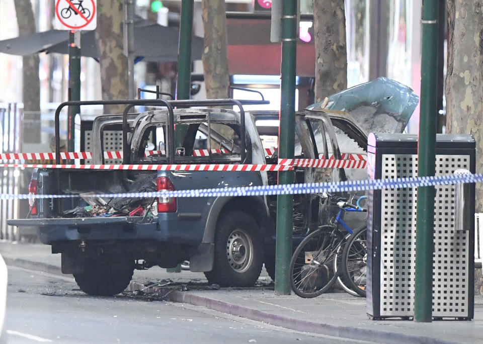 A burnt out vehicle is seen on Bourke Street in Melbourne on Friday Source: AAP