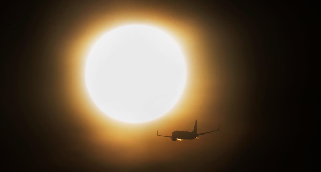 An airplane takes off from Southwest Florida International Airport after sunrise on Wednesday, July 26, 2023. Saharan dust is blanketing parts of the state of Florida.
