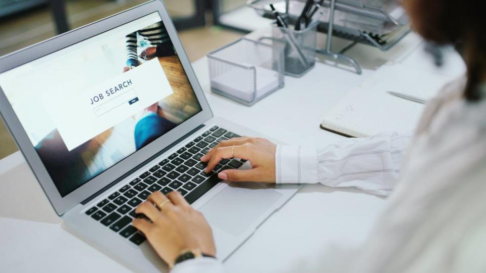 Shot of a businesswoman using a laptop to search for job vacancies