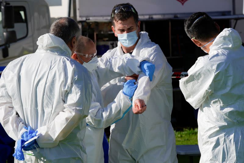 Response personnel prepare to enter a public housing tower, locked down in response to a COVID-19 outbreak, in Melbourne