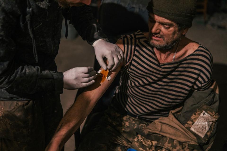 In this photo provided by Azov Special Forces Regiment of the Ukrainian National Guard Press Office, an Azov Special Forces Regiment's serviceman receives treatment inside the Azovstal steel plant in Mariupol, Ukraine, Tuesday, May 10, 2022 (Azov Special Forces Regiment of the Ukrainian National Guard Press Office)
