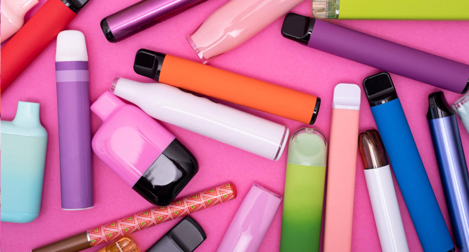 Colourful vapes on a pink background.