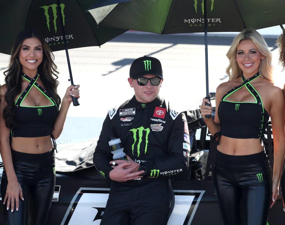 NASCAR Cup Series driver Ty Gibbs, center, is shaded by two of the Monster Energy Girls prior to the NASCAR All-Star Open at North Wilkesboro Speedway in North Wilkesboro, NC on Sunday, May 19, 2024. Gibbs held off driver Bubba Wallace to win the race.