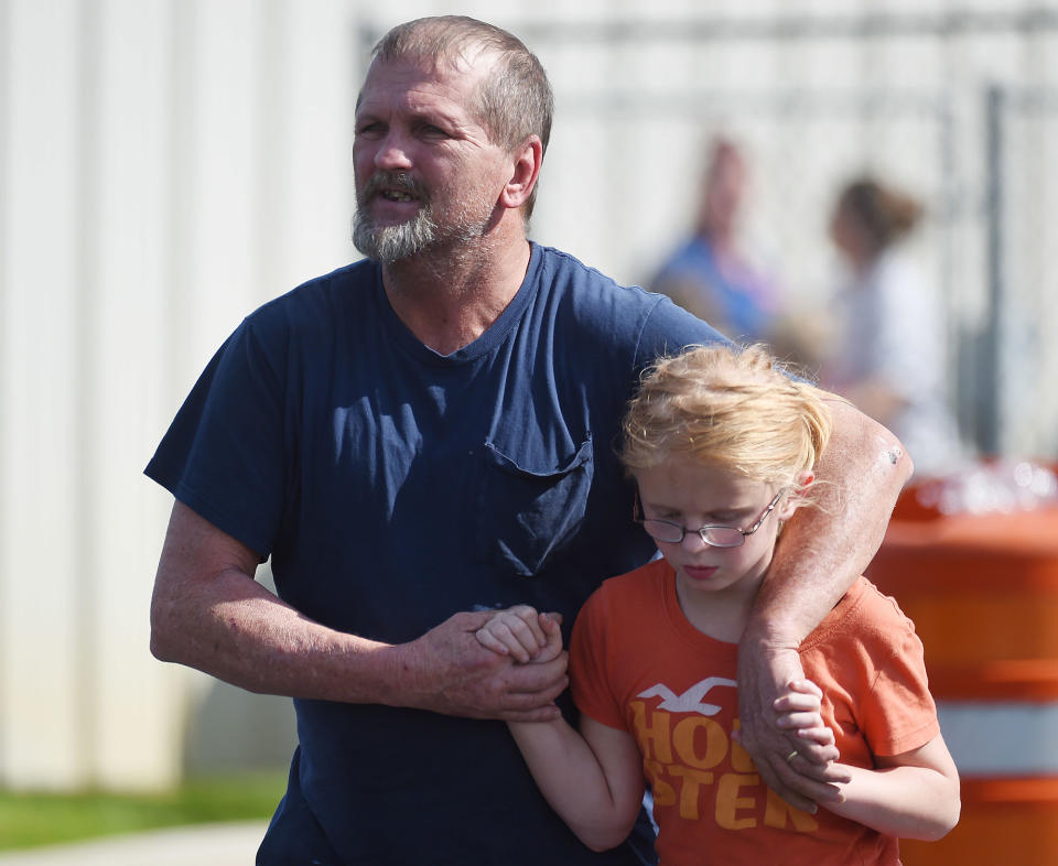 <p>Joey Taylor walks with his daughter Josie Taylor after picking her up at Oakdale Baptist Church on Wednesday, Sept. 28, 2016, in Townville, S.C. Students were evacuated to the church following a shooting at Townville Elementary School. A teenager opened fire at the South Carolina elementary school Wednesday. (AP Photo/Rainier Ehrhardt) </p>