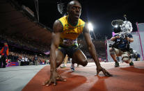 Jamaica's Usain Bolt crouches on the track after winning the men's 100m final during the London 2012 Olympic Games at the Olympic Stadium August 5, 2012. Bolt came first ahead of compatriot Yohan Blake who finished second and Justin Gatlin of the U.S. who placed third. REUTERS/Kai Pfaffenbach (BRITAIN - Tags: SPORT ATHLETICS OLYMPICS) 