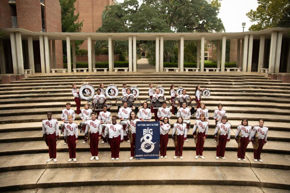 Aidan Wester (front row third to right) takes a photo with the FSU Marching Chiefs drumline.