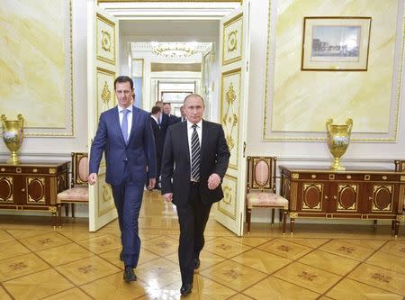 FILE PHOTO: Russian President Vladimir Putin (R) and Syrian President Bashar al-Assad enter a hall during a meeting at the Kremlin in Moscow, Russia, October 20, 2015. Alexei Druzhinin/RIA Novosti/Kremlin/via REUTERS