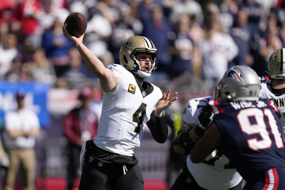 New Orleans Saints quarterback Derek Carr (4) passes under pressure from New England Patriots defensive end Deatrich Wise Jr. (91) during the first half of an NFL football game, Sunday, Oct. 8, 2023, in Foxborough, Mass. (AP Photo/Charles Krupa)