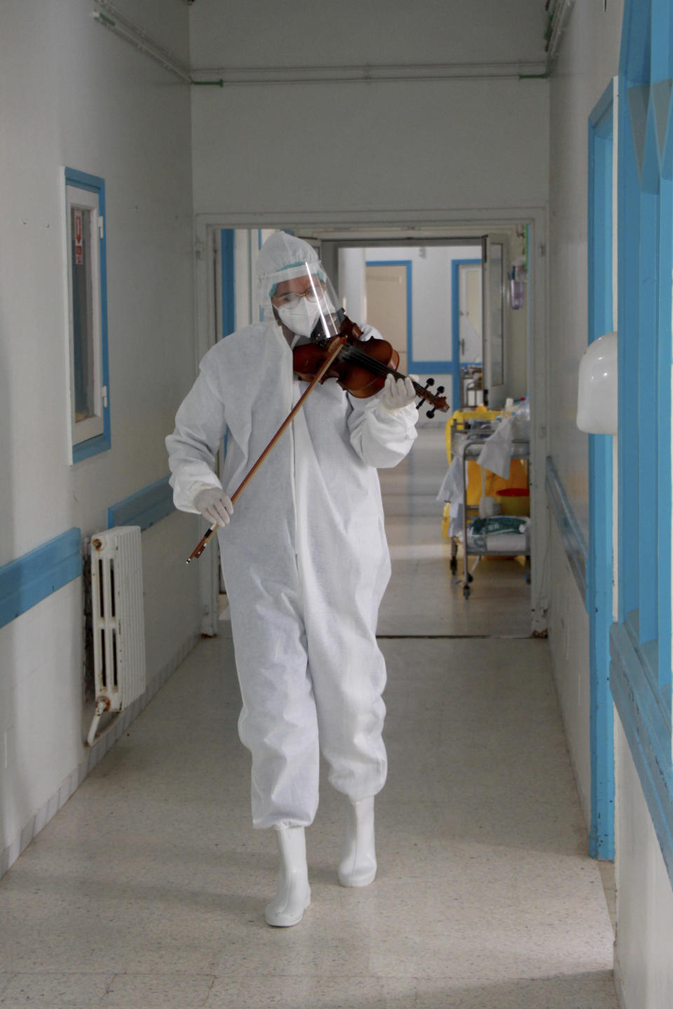 Dr. Mohamed Salah Siala plays the violin for patients on the COVID wards of the Hedi Chaker hospital in Sfax, eastern Tunisia, Saturday Feb. 20, 2021. When the 25-year-old decided to get out his violin one day at Hedi Chaker Hospital in city of Sfax and play, it won praise for boosting the morale of virus sufferers who remained isolated and needed a smile. (AP Photo)