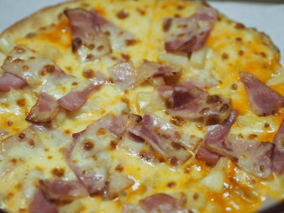 Hawaiian pizza with ham, bacon, and pineapple.