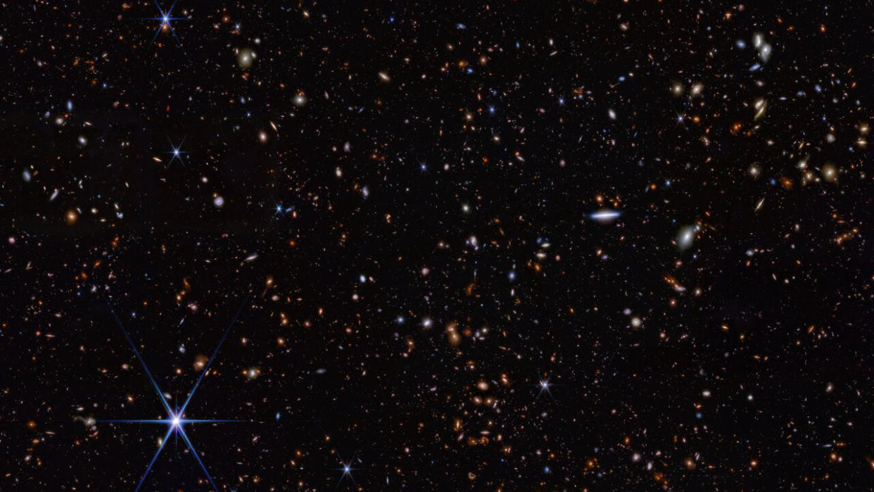  Telescope photo showing hundreds of galaxies in deep space. 