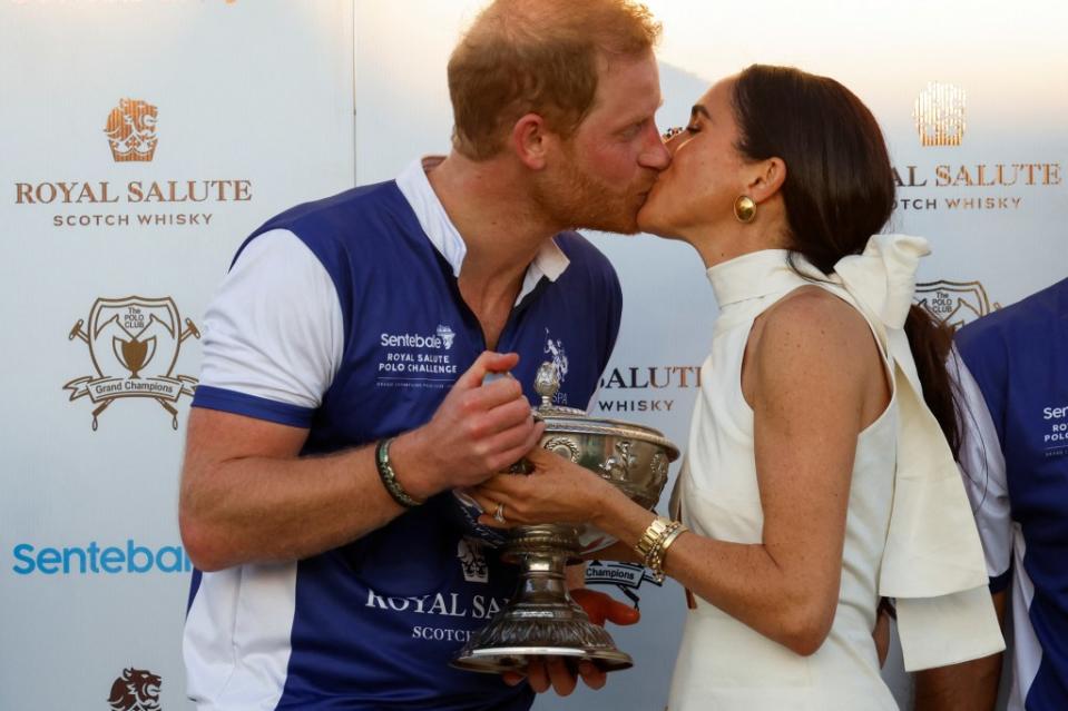 Britain’s Prince Harry and Meghan, Duchess of Sussex kiss as they attend the Royal Salute Polo Challenge to benefit Sentebale, a charity founded by him and Prince Seeiso of Lesotho. REUTERS