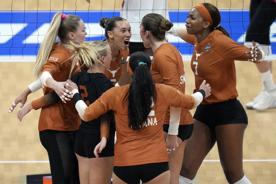 Texas players celebrate a point against Wisconsin during a semifinal match in the NCAA Division I women's college volleyball tournament Thursday, Dec. 14, 2023, in Tampa, Fla. (AP Photo/Chris O'Meara)