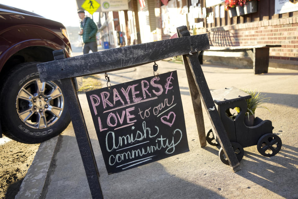 A sign on the sidewalk outside an antique store in Spartansburg, Pa., on Thursday, Feb. 29, 2024. The body of a pregnant 23-year-old Amish woman was discovered on Monday in her home a few miles outside of Spartansburg. Pennsylvania State Police are appealing for tips from the public to help solve the crime, a state police spokeswoman said Wednesday. (AP Photo/Gene J. Puskar)