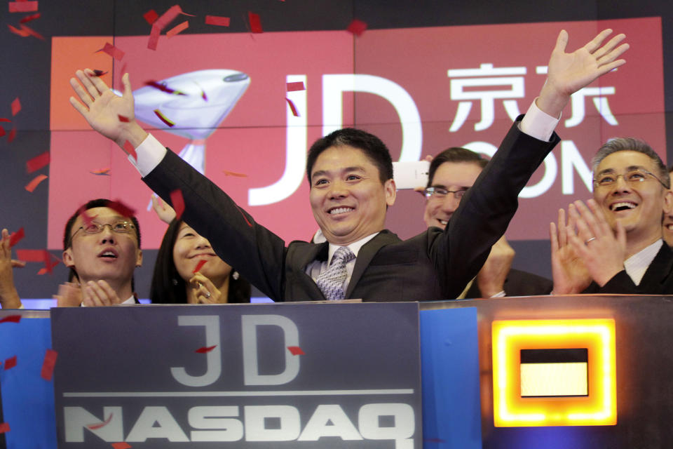 FILE - In this file photo taken Thursday, May 22, 2014, Liu Qiangdong, also known as Richard Liu, CEO of JD.com, raises his arms to celebrate the IPO for his company at the Nasdaq MarketSite, in New York. JD.com, China's No. 2 e-commerce service, is headquartered in Beijing. The Chinese e-commerce billionaire who faces a possible rape accusation in Minneapolis built his business by promising honesty in a market plagued by fraud and fakes. (AP Photo/Mark Lennihan, File)