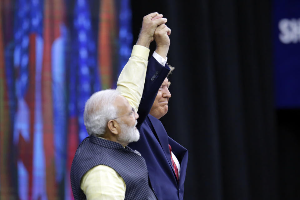 India Prime Minister Narendra Modi and President Donald Trump on stage during introductions at the "Howdi Modi" event Sunday, Sept. 22, 2019, at NRG Stadium in Houston. (AP Photo/Michael Wyke)