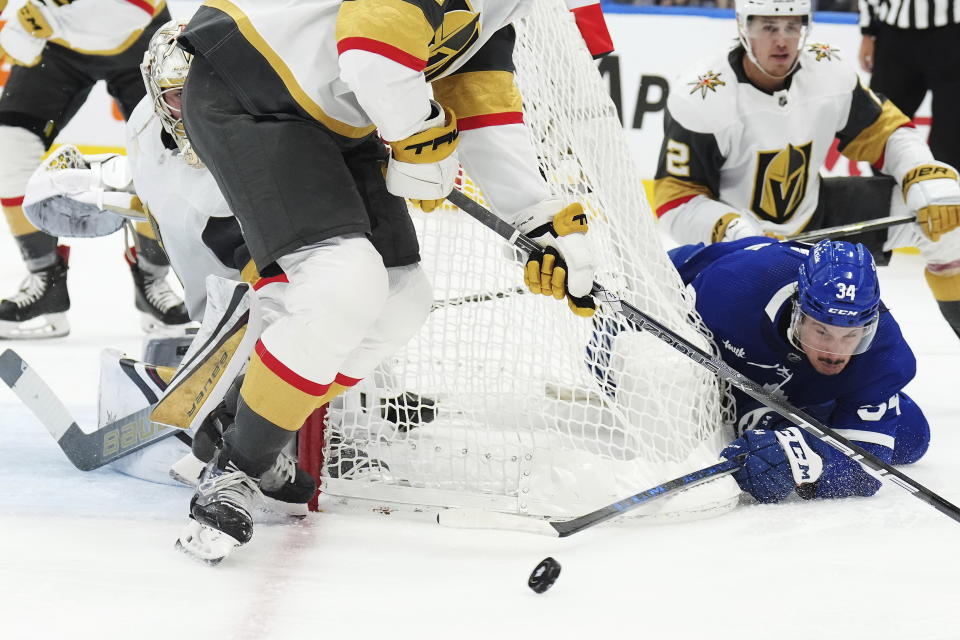 Toronto Maple Leafs forward Auston Matthews (34) tries a wrap around as Vegas Golden Knights defenseman Zach Whitecloud (2) defends during the second period of an NHL hockey game, Tuesday, Nov. 8, 2022 in Toronto. (Nathan Denette/The Canadian Press via AP)