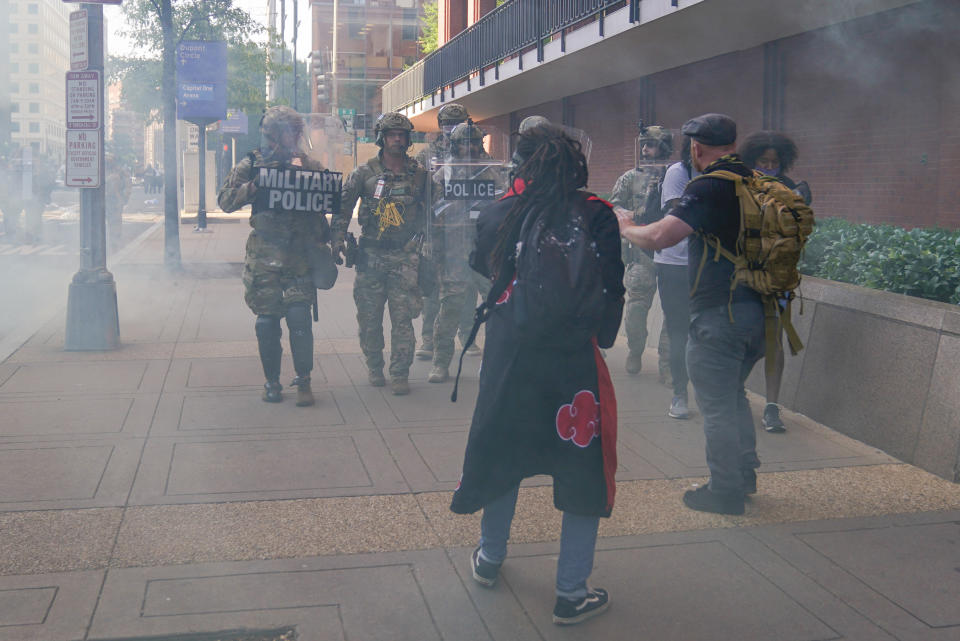 Military police begin to clear the sidewalks near the White House in Washington of demonstrators who had gather to protest the death of George Floyd, Monday, June 1, 2020. Floyd died after being restrained by Minneapolis police officers. (AP Photo/Evan Vucci)