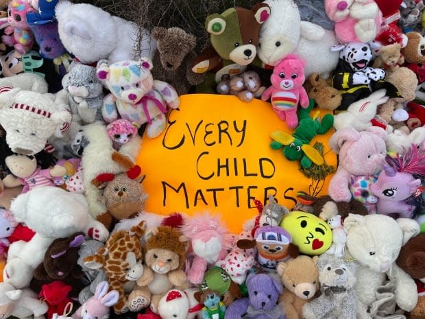 People heaped teddy bears and other childhood toys outside Happy Valley-Goose Bay's town hall Monday afternoon.