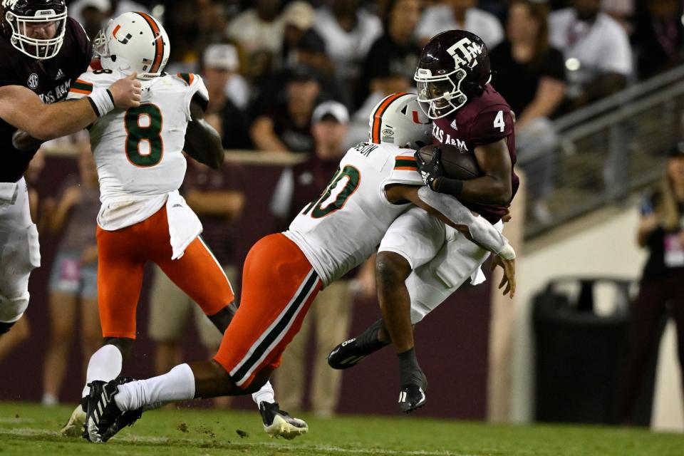 Miami linebacker Caleb Johnson (40) and Texas A&M running back Amari Daniels (4) in action during a September 2022 game.