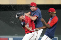 Minnesota Twins' Max Kepler, left, gets a water shower after his walk-off, bases-loaded single off Detroit Tigers pitcher Gregory Soto in the 10th inning of a baseball game, Monday, July 26, 2021, in Minneapolis. The Twins won 6-5. (AP Photo/Jim Mone)