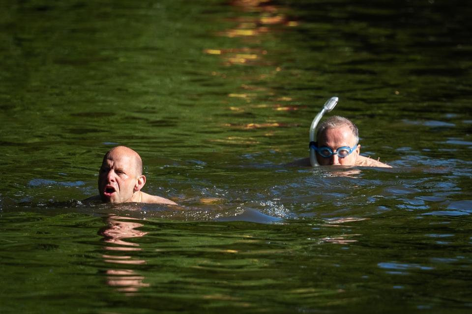 Swimmers in one of the Hampstead Heath ponds(PA)