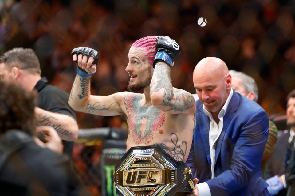 Sean O'Malley is given the belt by UFC president Dana White after defeating Aljamain Sterling during their UFC 292 Bantamweight title mixed martial arts fight, Saturday, August 19, 2023, in Boston. O'Malley won the title via 2nd round KO. (AP Photo/Gregory Payan),.