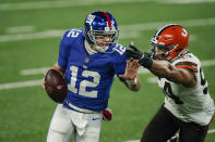 New York Giants quarterback Colt McCoy (12) evades Cleveland Browns' Olivier Vernon (54) during the first half of an NFL football game, Sunday, Dec. 20, 2020, in East Rutherford, N.J. (AP Photo/Seth Wenig)