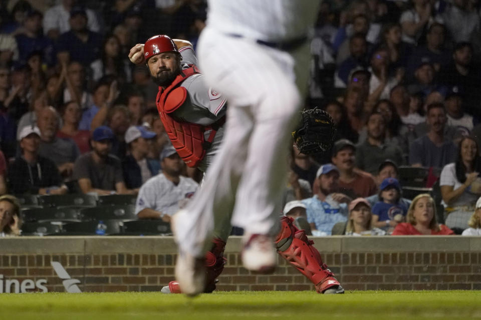 Cincinnati Reds catcher Austin Romine throws out Chicago Cubs' Yan Gomes at first during the sixth inning of a baseball game Tuesday, Sept. 6, 2022, in Chicago. (AP Photo/Charles Rex Arbogast)