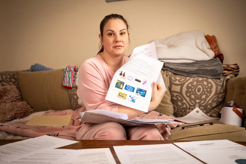 Sarah Duckett sifts through paperwork from her breast augmentation that she traveled from Florida to Ohio for. Sarah's surgeon, Dr. Katharine Roxanne Grawe, eventually had her license revoked after patients became injured under her care, according to the State Medical Board of Ohio.