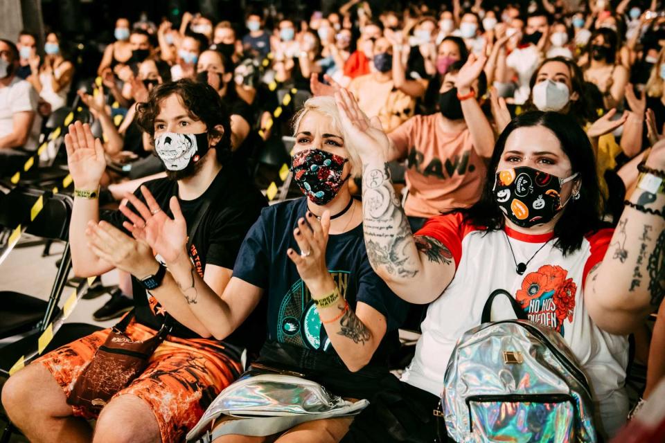 A view of fans wearing protective masks while Spanish rapper Rayden performs on stage at La Riviera