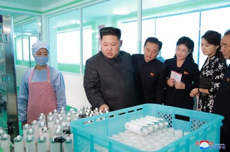 FILE PHOTO: North Korean leader Kim Jong Un and wife Ri Sol Ju visit a cosmetics factory in this undated photo released by North Korea's Korean Central News Agency (KCNA) in Pyongyang