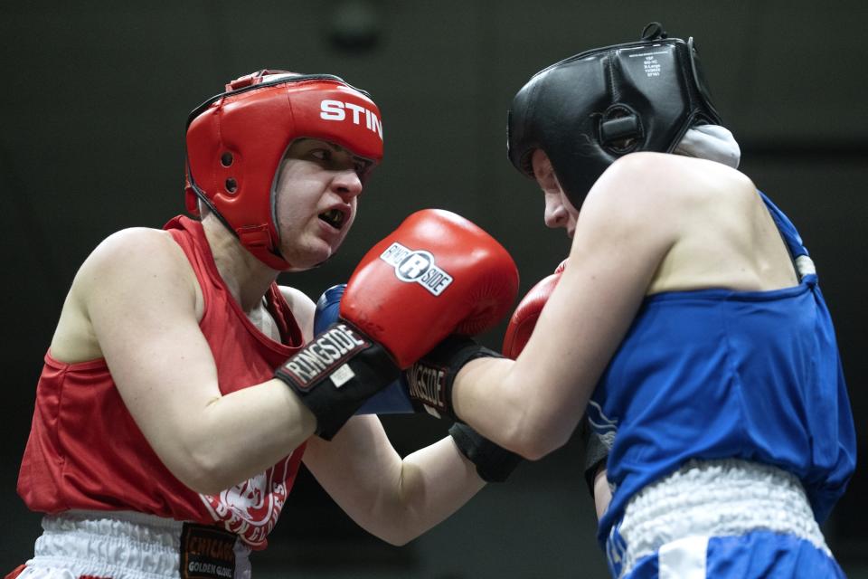 Claire Quinn, left, of Unanimous battles Stacey Parker of Tri-City in the 156-pound championship match on the final night of the 100th year of the Chicago Golden Gloves boxing tournament Sunday, April 16, 2023, in Cicero, Ill. (AP Photo/Erin Hooley)