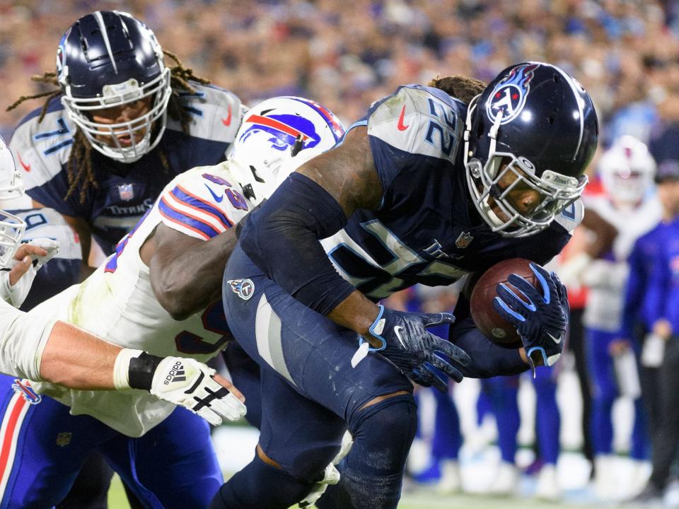 Derrick Henry breaks through a tackle against the Buffalo Bills.