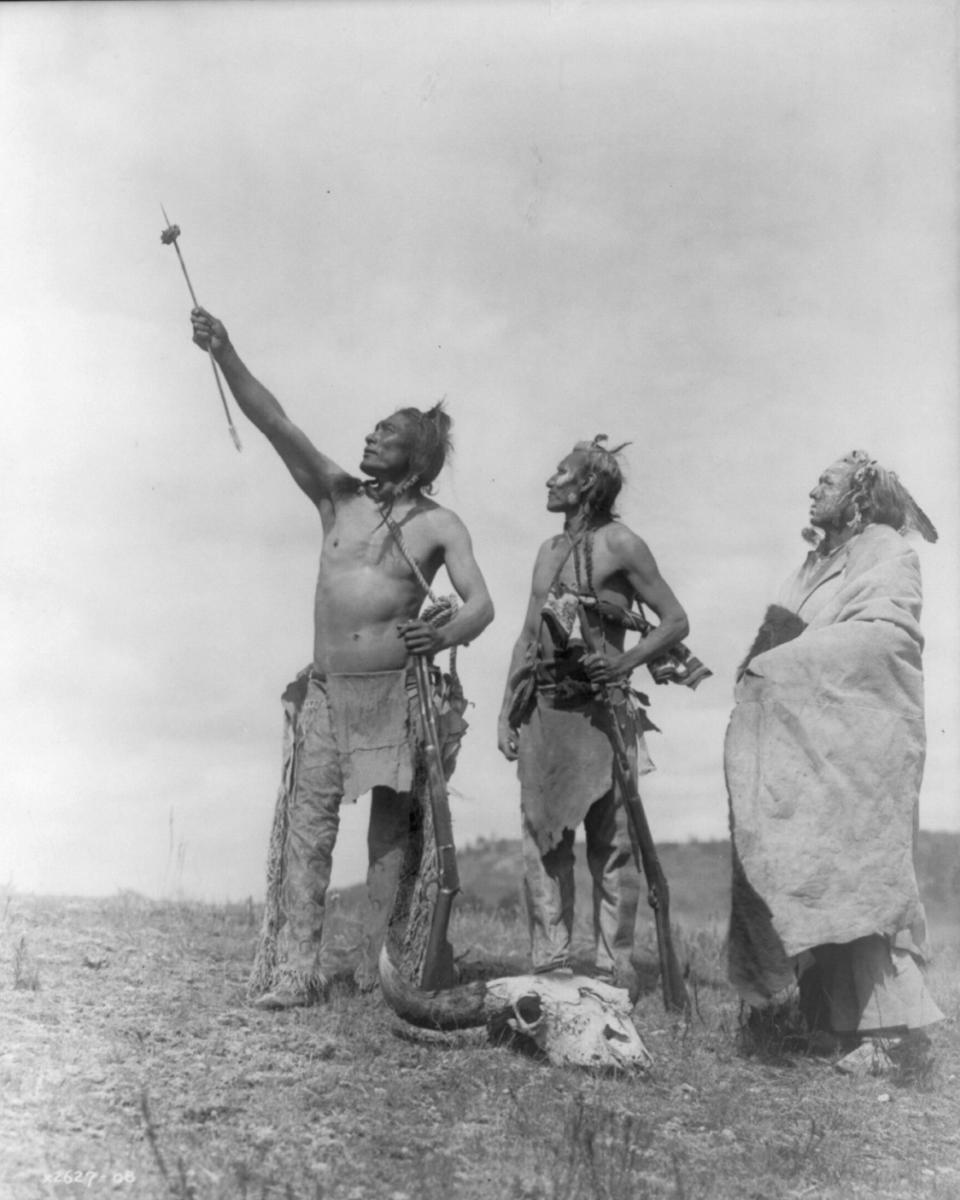 This circa 1908 photo made available by the Library of Congress shows three Apsaalooke men gazing skyward, two holding rifles, and a bison skull at their feet. At left is Pretty Tail and at center is Goes Ahead. Their tribe is also known as Crow. “It’s important to recognize the history that Native people had with buffalo and how buffalo were nearly decimated. … Now with the resurgence of the buffalo, often led by Native nations, we’re seeing that spiritual and cultural awakening as well that comes with it,” says Troy Heinert, a Rosebud Sioux Tribe member who serves as executive director of the InterTribal Buffalo Council. (Edward S. Curtis/Library of Congress via AP)