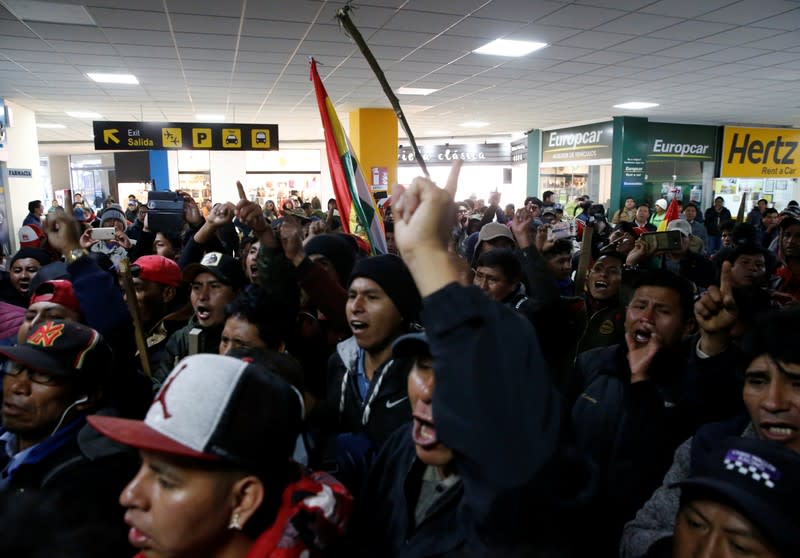 Supporters of Bolivia's President Evo Morales protest against Luis Fernando Camacho, President of Civic Committee of Santa Cruz, at the El Alto airport, on the outskirts of La Paz