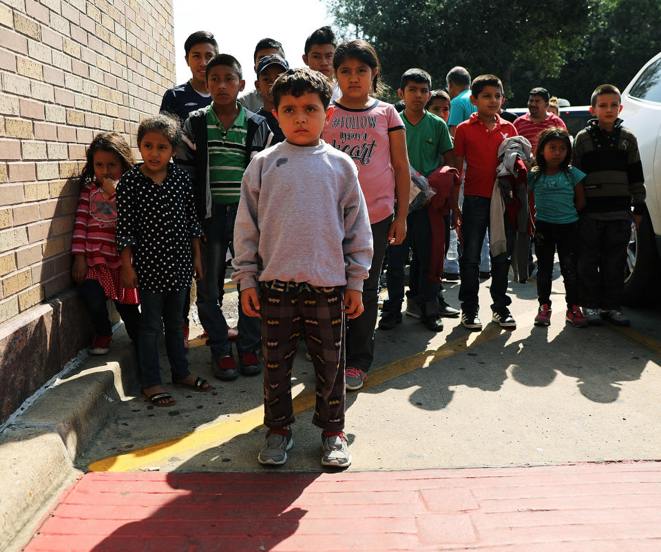 <span class="s1">Dozens of adults and their children, many fleeing poverty and violence in Honduras, Guatemala and El Salvador, arrive at a bus station following release from Customs and Border Protection on June 23 in McAllen, Texas. (Photo: Spencer Platt/Getty Images)</span>