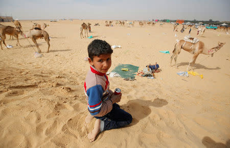 Yousef, a 7-year-old jockey, looks on during the opening of the International Camel Racing festival at the Sarabium desert in Ismailia, Egypt, March 21, 2017. Picture taken March 21, 2017. REUTERS/Amr Abdallah Dalsh