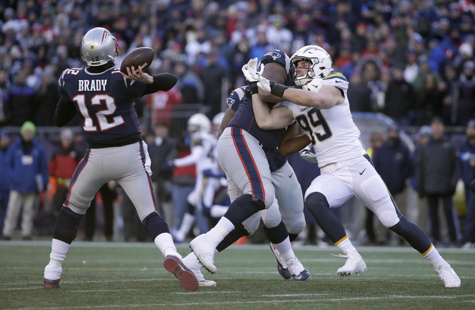 Getting to Tom Brady in the pocket has been extremely difficult in the playoffs for New England’s opponents. (AP)