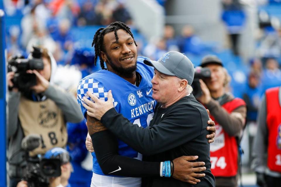 Kentucky rush end/outside linebacker J.J. Weaver (13) hugged UK Coach Mark Stoops before the Wildcats defeated archrival Louisville 26-13 on Nov. 26. Weaver, a product of Moore High School in Louisville, tied for the UK team lead with seven tackles in the game.