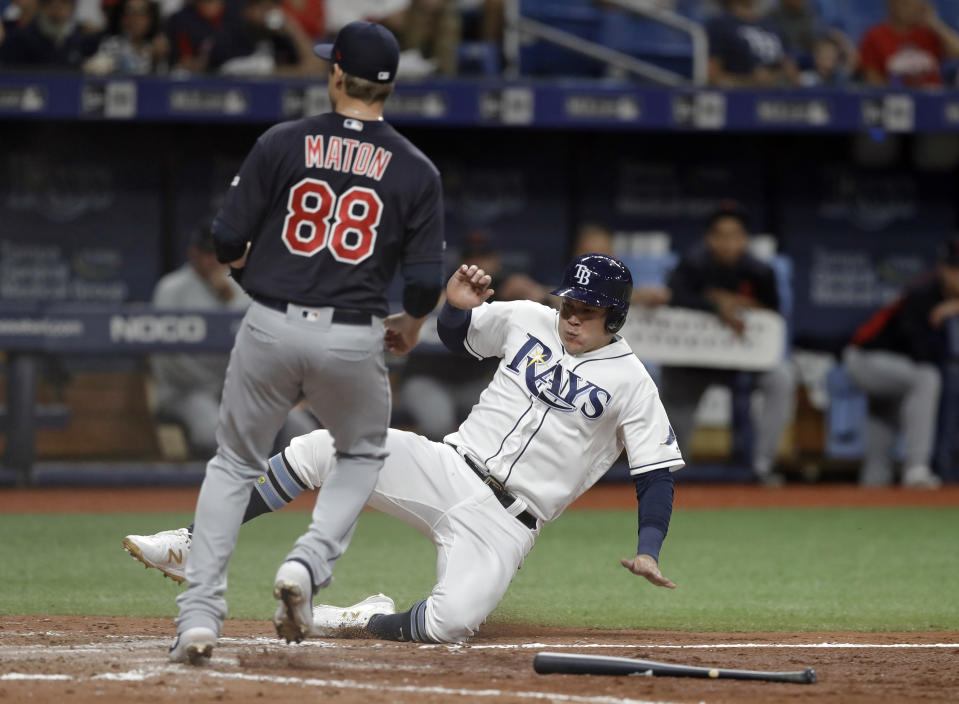 Tampa Bay Rays' Avisail Garcia scores ahead of the throw to Cleveland Indians relief pitcher Phil Maton (88) on a throwing error by first baseman Carlos Santana during the seventh inning of a baseball game Saturday, Aug. 31, 2019, in St. Petersburg, Fla. (AP Photo/Chris O'Meara)