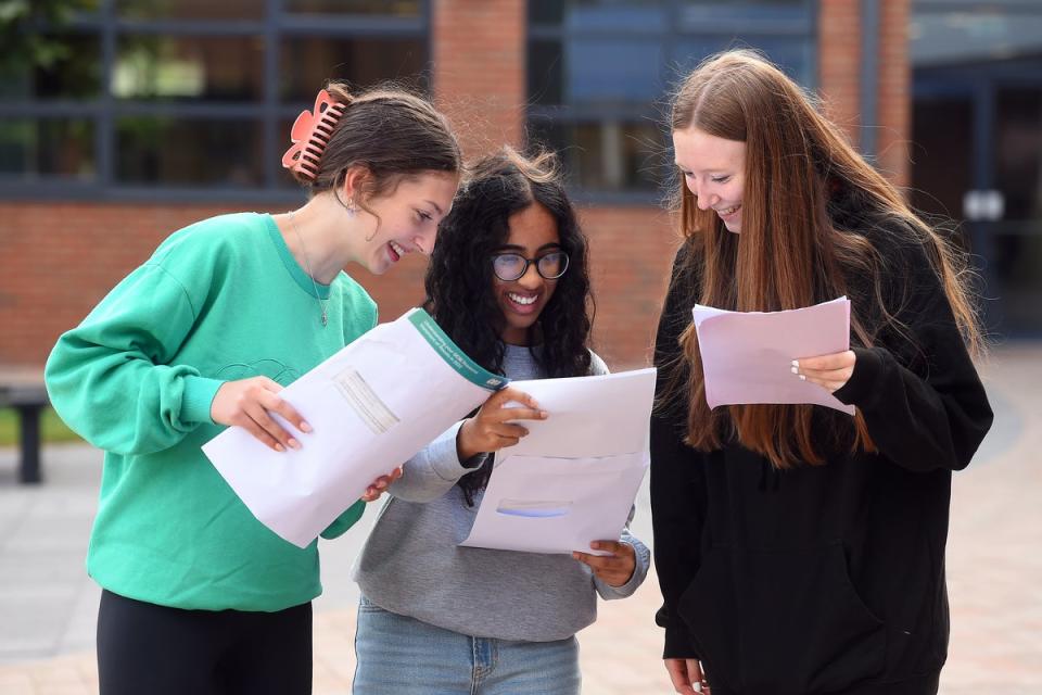 Pupils at Our Lady and St Patrick’s College in east Belfast read their results (Oliver McVeigh/PA) (PA Wire)