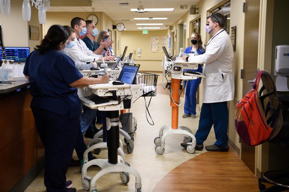 Dr. Ben Bevill conducts rounds on patients at University of Tennessee Medical Center’s Heart Hospital. He's hopeful because ECMO treatment can really help some of the sickest COVID-19 patients, but the process is long and incredibly labor-intensive.