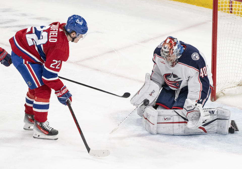 Columbus Blue Jackets goaltender Daniil Tarasov (40) makes a save against Montreal Canadiens' Cole Caufield (22) during the second period of an NHL hockey game Tuesday, March 12, 2024, in Montreal. (Christinne Muschi/The Canadian Press via AP)