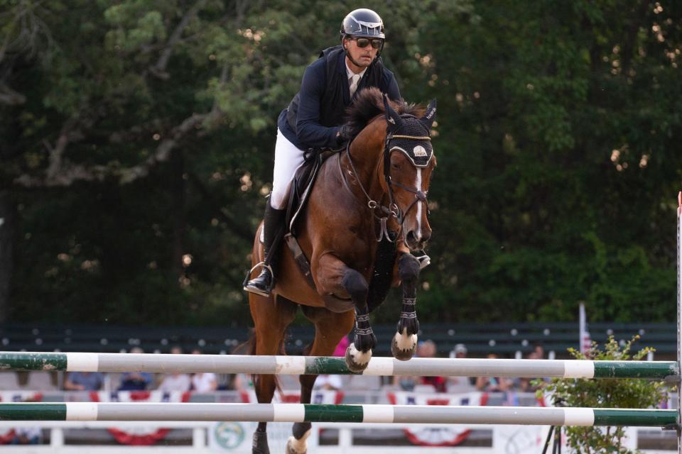 Michael Tokaruk and Destiny jump over an obstacle in the Hunter/Jumper Versatility Challenge during the Germantown Charity Horse Show in Germantown, Tenn., on Tuesday, June 6, 2023. 