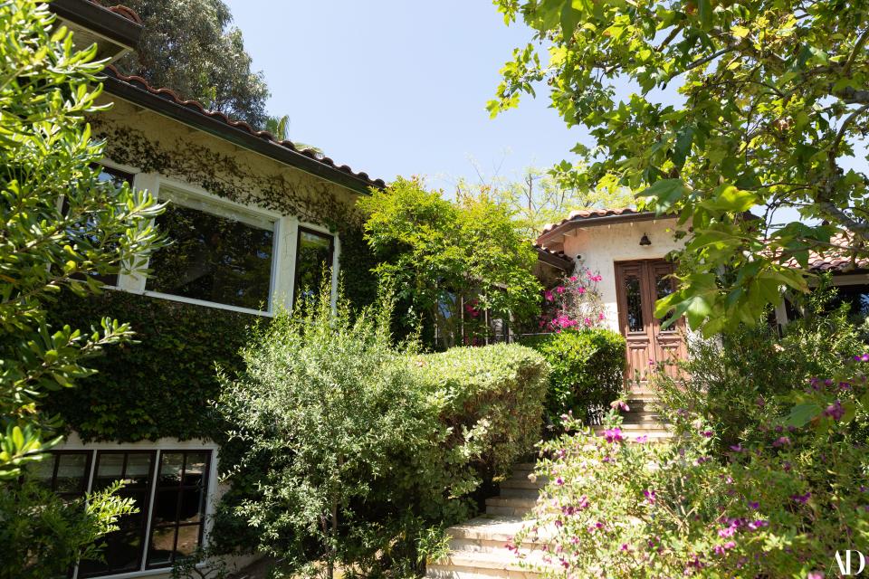 The Spanish-style residence’s exterior is decorated, lushly, with climbing plants and flowers. Stamos intimates that his son is the best gardener of the bunch.